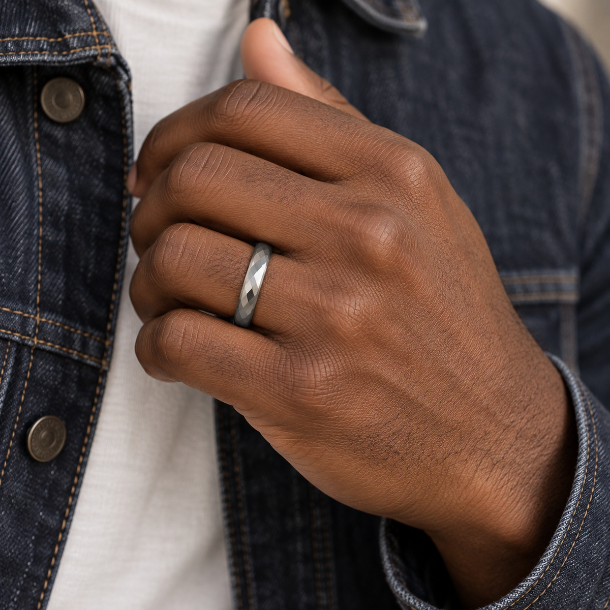 Lifestyle view of 4mm Tungsten Faceted Domed Band worn on hand