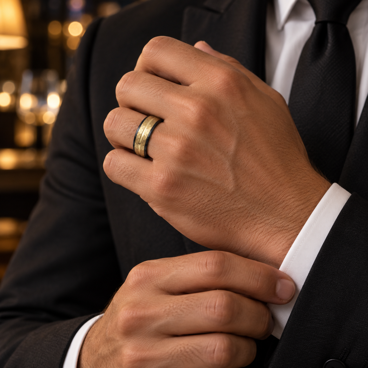 Lifestyle view of 8mm Black & Yellow Tungsten Hammered Groove Band worn on hand