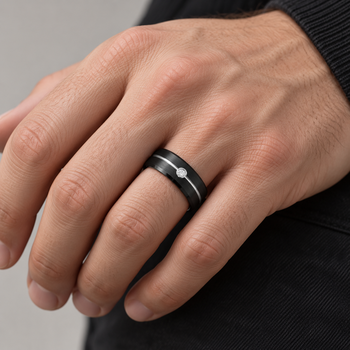Lifestyle view of 8mm Black Tungsten Band with White Groove & Diamond worn on hand