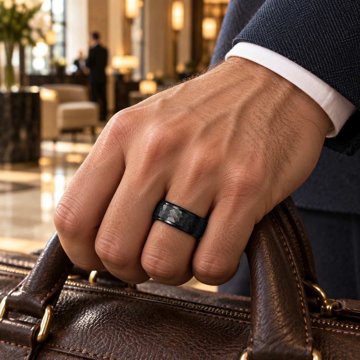 Lifestyle view of 8mm Black Tungsten Hammered Band with Polished Stepped Edges worn on hand