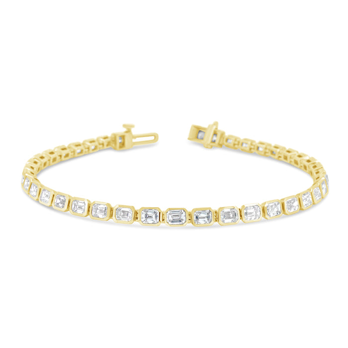 A gold-colored bracelet featuring a series of emerald-cut diamonds
