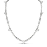 A 16-inch tennis necklace with a 7-pear shape and 2 round cuts, set in 18k gold.