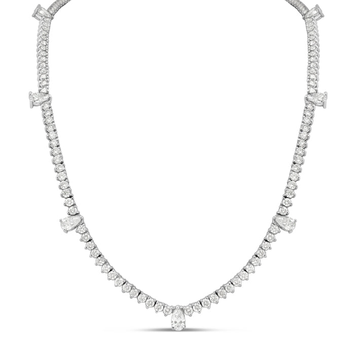 A 16-inch tennis necklace with a 7-pear shape and 2 round cuts, set in 18k gold.