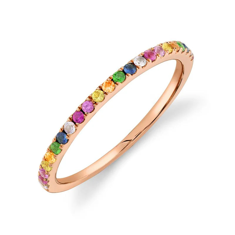 A multi-color stone stackable ring with sapphire, ruby, and green garnet on a gold-tone band