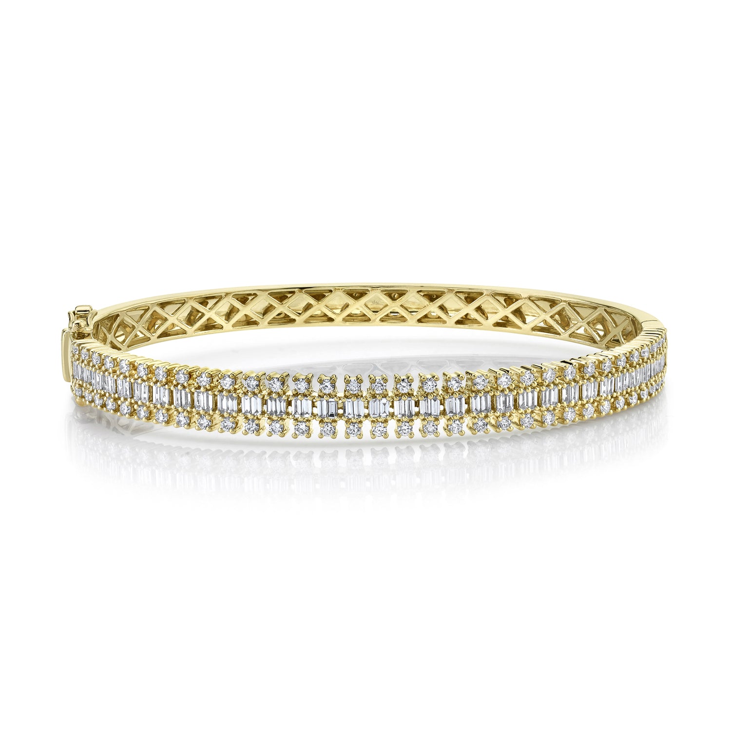 A 14K gold bangle bracelet with a geometric pattern, featuring baguette and round cut diamonds.