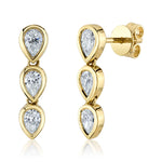 A pair of gold bezel pear stud earrings with diamond details.