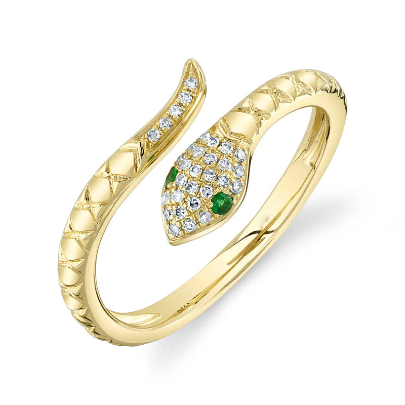 A gold ring featuring a snake-like design with emerald and diamond accents.