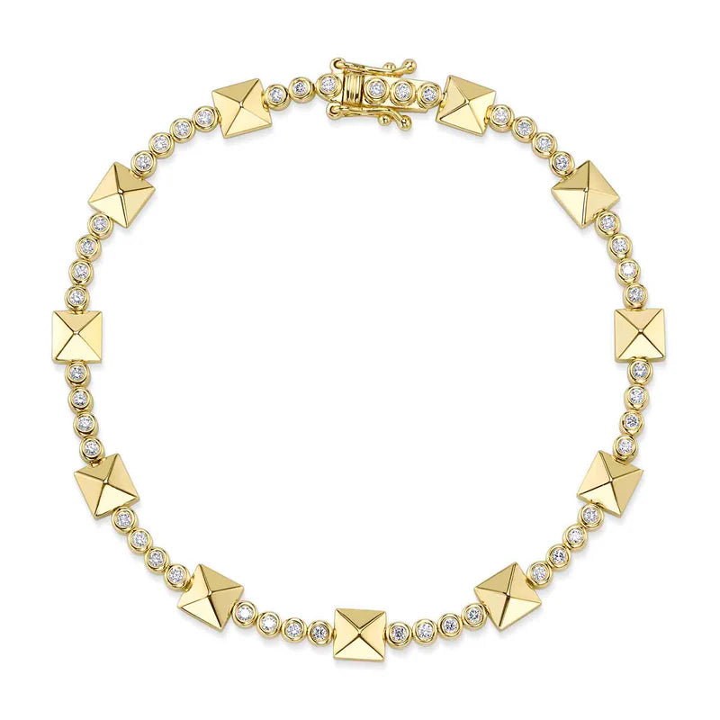 A gold-colored bracelet featuring a series of diamond-encrusted geometric pyramids.