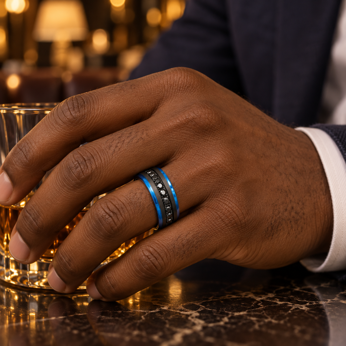 8mm black and blue tungsten band with black diamond channel worn on hand in lifestyle setting