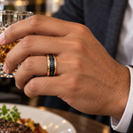 8mm black and rose tungsten band with black diamond channel worn on hand in lifestyle setting