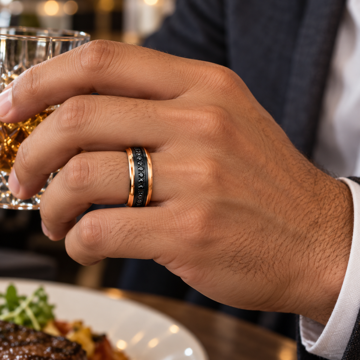 8mm black and rose tungsten band with black diamond channel worn on hand in lifestyle setting